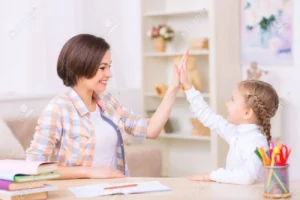 50835615 high five gesture mom and daughter are smiling and high fiving each other